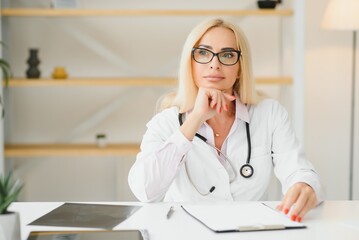 Middle age woman wearing doctor uniform at clinic