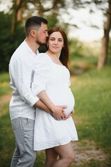 Pregnant woman with her family looking happy