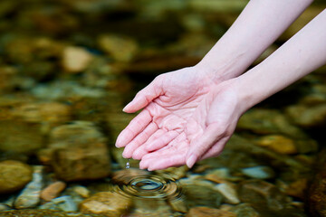 川の水を救う女性の手元