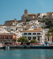Port, old town and Castle of Ibiza. Sa Marina neighborhood and the historic complex of Dalt vila with blue sky and sea.