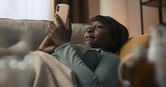 Young woman is browsing popular websites on smartphone, fixated on opportunity to shop online. The girl is happy because she could do shopping without leaving home . Online shopping.
