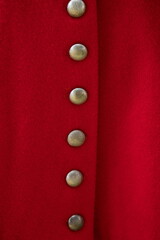 Vintage metal buttons on a red garment