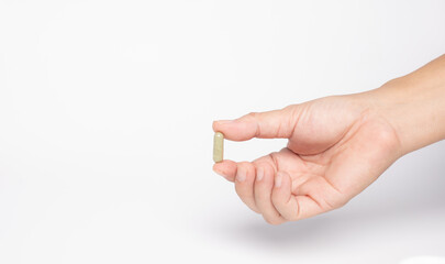 hand hole Green chiretta herbal capsule medicine,on white background