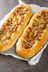 Open meat pie with egg, stuffed bread, pizza close-up on parchment on the table. Vertical