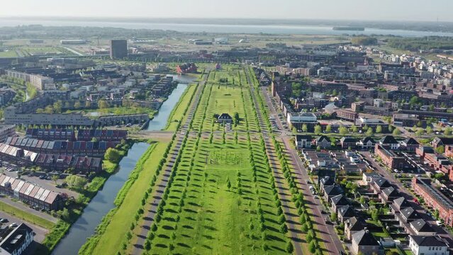 Green area in Almere Poort district of a modern growing city in The Netherlands, province Flevoland, suburb of Amsterdam. Aerial drone shot.