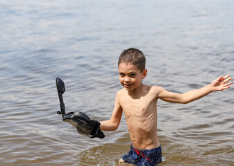 the boy goes ashore in an underwater mask