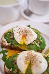 Freshly made poached egg and Avocado toasts on light grey background