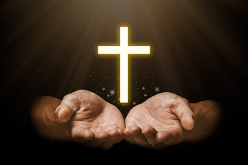 Praying hand with jesus christ and shadows reaching out against a dark background.Christian life crisis prayer to god.