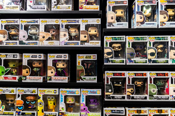 Fototapeta premium a shelf with lots of superhero toys in boxes. Funko pops
