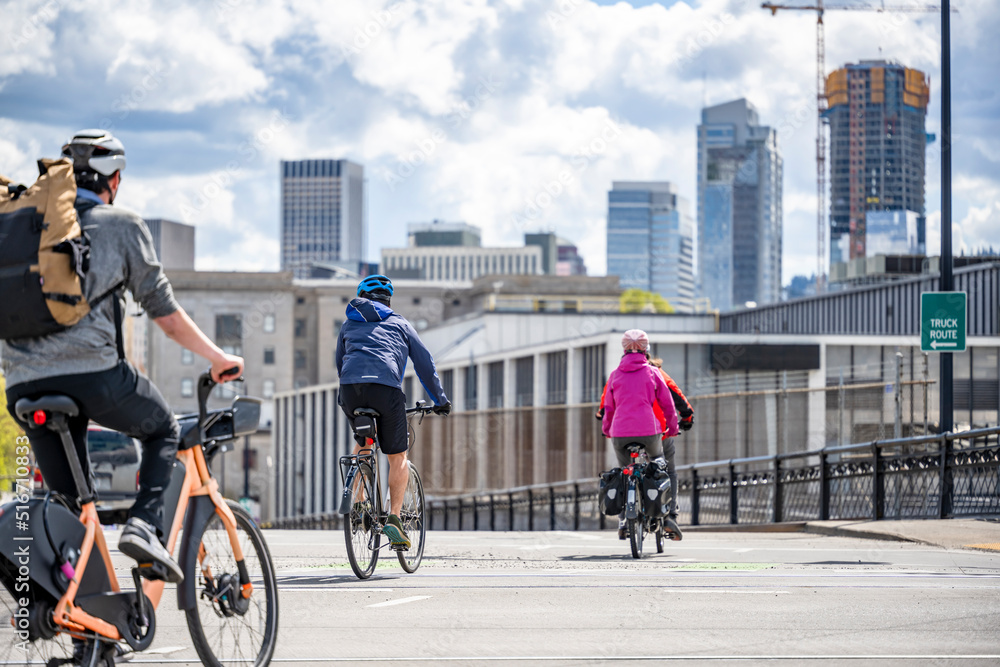 Wall mural group of amateur cyclists make a bicycle trip through the streets of a modern city.