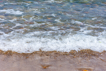 View of tiny Mediterranean sea waves. Summer vacation concept.