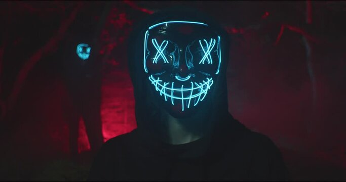 Demon with glowing mask in forest. Close Up