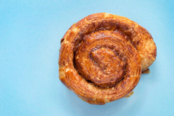 Fototapeta premium Cinnamon roll on blue