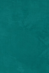 Saturated emerald green colored low contrast Concrete textured background. Empty colourful wall texture with copy space for text overlay and mockups. 2023, 2024 color trend