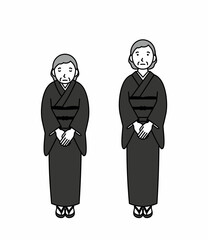 お辞儀をする喪服のシニア女性