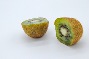 a kiwi fruit cut in half on white background