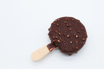 round chocolate ice cream and almond pieces on white background