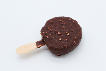 round chocolate ice cream and almond pieces on white background