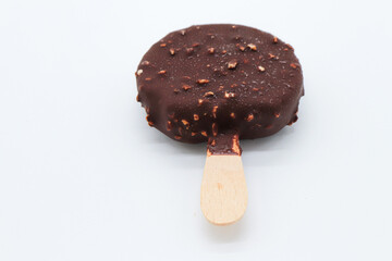 round chocolate ice cream and almond pieces on white background
