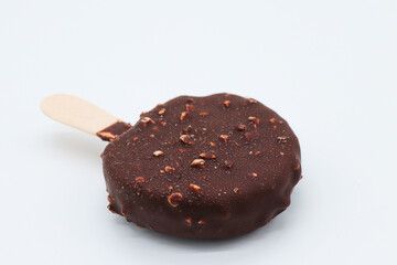 round chocolate ice cream and almond pieces on white background