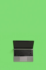 Fototapeta na wymiar Top view of modern laptop isolated on green background. Copy space