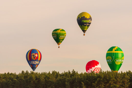 Leszno, Poland - June, 17, 2022: Antidotum Airshow Leszno, flight of colored balloons over the airport during air shows at sunset.