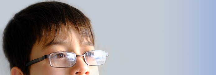 closeup child's face, eyes of boy 10-12 years old in glasses, concept of vision examination,...