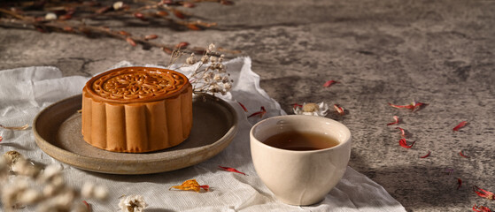 Mid Autumn moon cake and tea decoration with dried flower on stone table. Mid Autumn festival or Chinese traditional festival