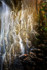 A large waterfall in the sun's rays tropical mysterious fairy jungle