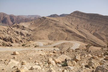 Beautiful mountain panorama with winding KINGS HIGHWAY JORDAN during access to Wadi Ghuweir Canyon in Dana Biosphere Reserve in Jordan. 