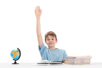 Know-it-all boy raised his hand high in class. Portrait of schoolboy with notebooks and textbook....