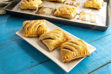 puff pastry with strawberries on wooden background. food concept