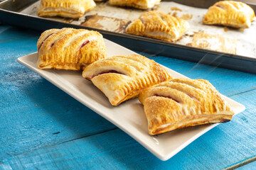 puff pastry with strawberries on wooden background. food concept