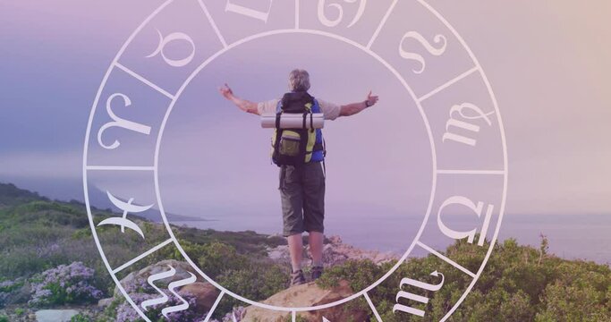 Animation of horoscope over caucasian male hiker in mountains