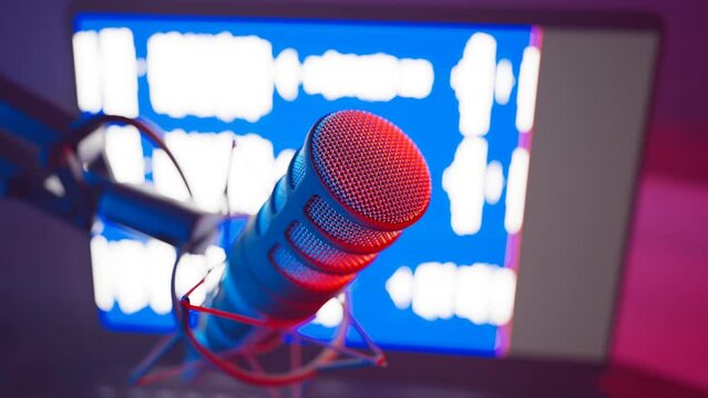 Colourful vocal microphone during podcast animation. DAW sound waves on a screen