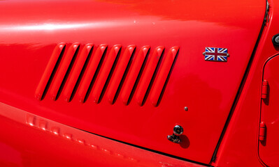 detail of the bonnet of a red car