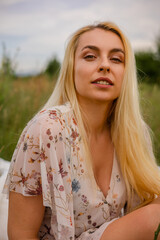 Fototapeta premium beautiful young woman with a bouquet of flowers in the park