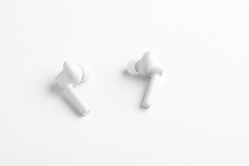 Obraz premium Technology concept : wireless ear bud or headphone on white background.