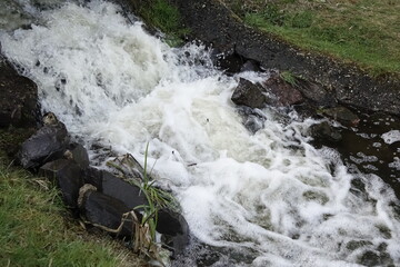 Water cascade with strong current at small lake Schwarzweiher in Palatinate landscape, concept: refreshment, outdoor, power (horizontal), Enkenbach-Alsenborn, RLP, Germany