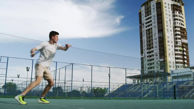4K. The guy is a tennis player with a racket and a ball, the man is preparing to hit the ball with a racket
