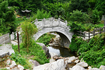 a stone bridge over a stream