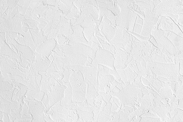 abstract background of white embossed plastered wall painted white close up