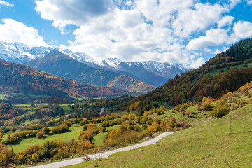 Naklejka na ściany i meble Beautiful autumn landscape of the Caucasus mountains, serpentine on a sunny day, Svaneti, Georgia