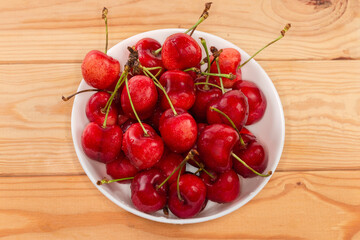 Washed red sweet cherries on stems in the bowl