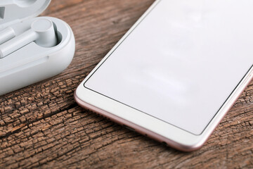 Wireless ear buds or headphone with smartphone. technology concept.