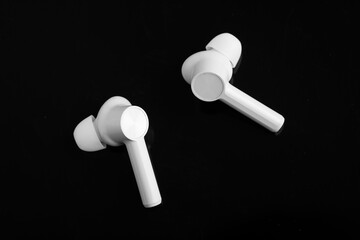 Technology concept : wireless ear bud or headphone on black background.