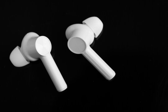 Technology concept : wireless ear bud or headphone on black background.