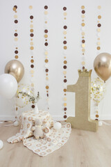 photo zone with a golden number and balloons for the first birthday
