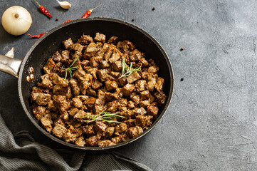 Cooked Fried liver in pan on rustic background, giblets food