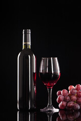 wine glass with red wine on black background